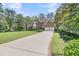 Charming brick home featuring a well-manicured lawn, long driveway, and attached garage at 8662 W Fairway Woods Dr, North Charleston, SC 29420