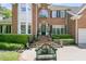 Close-up of a brick home with a manicured lawn, landscaped garden, and charming front entrance at 8662 W Fairway Woods Dr, North Charleston, SC 29420
