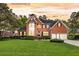 Beautiful two-story brick home with manicured lawn, black shutters, mature trees and two-car garage at 8662 W Fairway Woods Dr, North Charleston, SC 29420