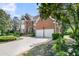 Beautiful two-story brick home with a well-manicured front yard and a circular driveway at 8662 W Fairway Woods Dr, North Charleston, SC 29420