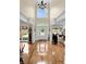 Grand foyer with a two-story ceiling, decorative tile floor, and elegant chandelier at 8662 W Fairway Woods Dr, North Charleston, SC 29420