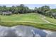 Scenic golf course view with a walking path and tranquil pond, perfect for a relaxing day outdoors at 8662 W Fairway Woods Dr, North Charleston, SC 29420