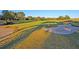Scenic golf course featuring a sand trap, lush green grass, and manicured landscaping for golfers to enjoy at 8662 W Fairway Woods Dr, North Charleston, SC 29420
