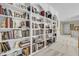 Hallway with book shelves and carpet throughout that connects to the other rooms of the home at 8662 W Fairway Woods Dr, North Charleston, SC 29420