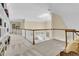 Spacious upper hallway featuring off white carpet, white railings, and large, built in shelving unit at 8662 W Fairway Woods Dr, North Charleston, SC 29420