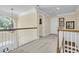 Second story hallway featuring stairs and a large arched window with views to the property at 8662 W Fairway Woods Dr, North Charleston, SC 29420