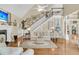 Elegant living room with staircase, fire place, hardwood floors, and traditional decor at 8662 W Fairway Woods Dr, North Charleston, SC 29420