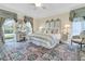 Charming main bedroom with elegant bedding, furnishings and natural light at 8662 W Fairway Woods Dr, North Charleston, SC 29420