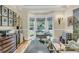Bright office with a bay window, built-in shelves, and a spacious desk at 8662 W Fairway Woods Dr, North Charleston, SC 29420