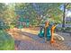 Outdoor playground featuring a variety of play structures set in a safe, wood-chip ground cover perfect for Gathering fun at 8662 W Fairway Woods Dr, North Charleston, SC 29420