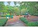 A colorful community playground with various play structures, benches, and lush landscaping, offering fun for children at 8662 W Fairway Woods Dr, North Charleston, SC 29420