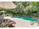Lounge by the pool surrounded by lush greenery and palm trees, ideal for relaxation at 8662 W Fairway Woods Dr, North Charleston, SC 29420