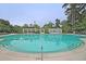 Community pool facility featuring a large swimming pool, covered seating areas, and well-maintained landscaping for residents at 8662 W Fairway Woods Dr, North Charleston, SC 29420