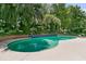 Sparkling pool with mature landscaping, perfect for a refreshing swim and relaxation at 8662 W Fairway Woods Dr, North Charleston, SC 29420
