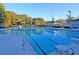 Large community pool with clear blue water, multiple lanes, lounge chairs, and a shaded pavilion for relaxing poolside at 8662 W Fairway Woods Dr, North Charleston, SC 29420