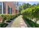 Brick home featuring a landscaped side yard with a stone pathway at 8662 W Fairway Woods Dr, North Charleston, SC 29420