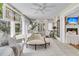 Bright sunroom with white decor, tile floors and view of the backyard at 8662 W Fairway Woods Dr, North Charleston, SC 29420