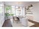 Bright dining room with large windows, stylish chandelier, modern furniture, built in shelves and hardwood floors at 952 Mccants Dr, Mount Pleasant, SC 29464