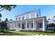 Stunning exterior elevation featuring a large porch, white siding, beautiful landscaping and meticulously crafted architectural design at 952 Mccants Dr, Mount Pleasant, SC 29464
