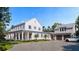 Inviting exterior with a long porch, manicured lawn, garage, and a paved driveway leading to the home's entrance at 952 Mccants Dr, Mount Pleasant, SC 29464