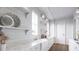 Charming kitchen showcasing shiplap walls, a farmhouse sink, marble countertops, open shelving, and ample natural light at 952 Mccants Dr, Mount Pleasant, SC 29464