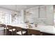 Open-concept kitchen featuring a large marble island, counter seating, elegant lighting, and premium stainless steel appliances at 952 Mccants Dr, Mount Pleasant, SC 29464