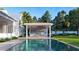 Backyard pool area featuring an outdoor kitchen with a grill and bar seating near a covered structure at 952 Mccants Dr, Mount Pleasant, SC 29464