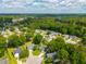 An aerial view of a neighborhood showcasing the houses surrounded by lush green trees and landscaped yards at 9590 Crosscut Dr, Ladson, SC 29456