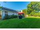 Spacious backyard featuring a well-maintained lawn, patio area, and lush greenery at 9590 Crosscut Dr, Ladson, SC 29456