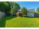 Lush backyard with mature trees, a well-kept lawn, and a covered patio area for outdoor enjoyment at 9590 Crosscut Dr, Ladson, SC 29456