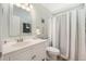 Bathroom with a white vanity, mirror, and shower with a grey and white curtain, plus nautical themed decorations at 9590 Crosscut Dr, Ladson, SC 29456