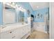 Bright bathroom featuring a white vanity, framed mirror, nautical decor, and a separate tub and shower at 9590 Crosscut Dr, Ladson, SC 29456