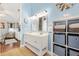This bathroom features a white vanity and decorative shelving, while the doorway offers a view of the bedroom at 9590 Crosscut Dr, Ladson, SC 29456