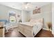 Inviting bedroom with a white bed, complemented by a window rocking chair, and wood-look flooring at 9590 Crosscut Dr, Ladson, SC 29456