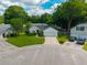 Aerial view of a one-story home on a cul-de-sac with well-maintained lawn, beautiful shrubbery, and an attached two-car garage at 9590 Crosscut Dr, Ladson, SC 29456