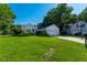 Well-maintained one-story home with a lush green lawn, mature landscaping, and a two-car attached garage at 9590 Crosscut Dr, Ladson, SC 29456