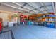 Well-organized garage with ample storage space, shelving, and a clean floor at 9590 Crosscut Dr, Ladson, SC 29456