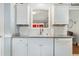 Bright kitchen featuring granite counters, a stainless steel sink, and white cabinetry at 9590 Crosscut Dr, Ladson, SC 29456