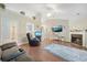 Open living room with hardwood floors, fireplace, ceiling fan, and vaulted ceiling offers comfortable seating at 9590 Crosscut Dr, Ladson, SC 29456