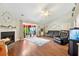 Cozy living room with a fireplace, hardwood floors, sliding glass doors to the patio, and comfortable seating at 9590 Crosscut Dr, Ladson, SC 29456