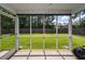 A view from the screened-in porch to a sprawling green lawn enclosed by a wood fence at 100 Pine Hall Dr, Goose Creek, SC 29445