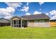 View of the home's rear exterior with siding, roof, lawn, a screened-in porch, and fenced-in yard at 100 Pine Hall Dr, Goose Creek, SC 29445