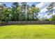 Spacious, well-maintained backyard with lush green grass and a tall wooden fence for privacy at 100 Pine Hall Dr, Goose Creek, SC 29445