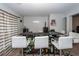 Finished basement bar with modern white stools, dark countertop, and shelving for bottles at 100 Pine Hall Dr, Goose Creek, SC 29445