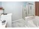 Bright bathroom featuring a modern shower and soaking tub, complete with gray tile flooring at 100 Pine Hall Dr, Goose Creek, SC 29445
