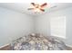 Bedroom with fan, window, and bed with patterned comforter at 100 Pine Hall Dr, Goose Creek, SC 29445
