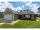 Charming single-story home with neutral siding, attached garage, and manicured front yard with palm tree at 100 Pine Hall Dr, Goose Creek, SC 29445
