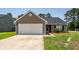Single-story home with neutral siding, dark roof, attached garage, and a well-maintained front lawn at 100 Pine Hall Dr, Goose Creek, SC 29445