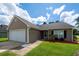 Charming single-story home with a manicured lawn, featuring a garage and cozy entrance at 100 Pine Hall Dr, Goose Creek, SC 29445