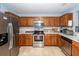 Well-lit kitchen with stainless steel appliances and wood cabinetry offering ample storage space at 100 Pine Hall Dr, Goose Creek, SC 29445